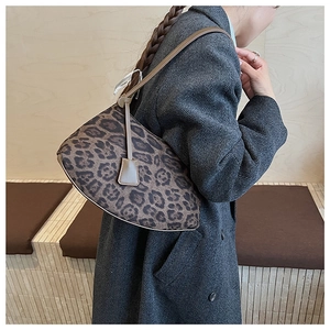 Detail of leopard print hobo bag with knotted leather strap on grey wool coat