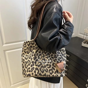 Leopard print faux suede tote bag with leather straps worn by model for casual style