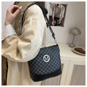 Detail of canvas crossbody bag with letter print and adjustable geometric woven strap