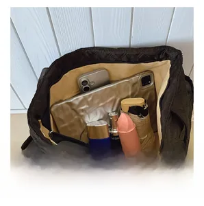 Detailed interior of black quilted tote bag showing large capacity for daily essentials