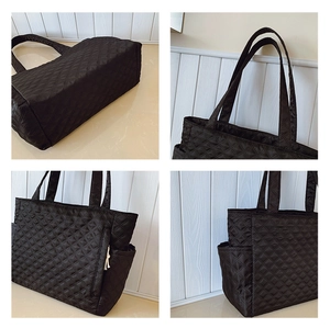 Detail view of black quilted tote bag showing rhombus stitching and side pocket design