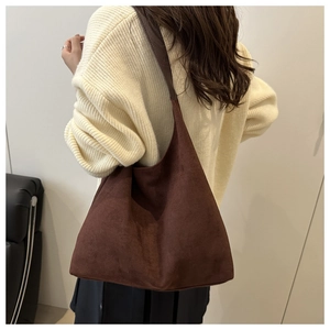 Detail of dark brown faux suede tote bag showing large capacity and soft matte texture