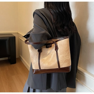 Side view of large contrast stitching tote bag on model for urban commute outfit