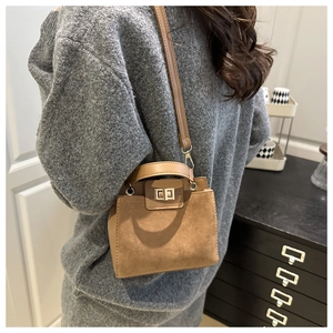 Brown retro shoulder bag with matte suede texture and metal twist lock detail