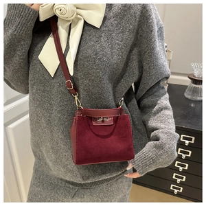 Detail of burgundy kelly bag showing the contrast between suede and smooth leather textures