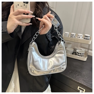 Silver crescent shoulder bag featuring chunky metal chain and rivet details