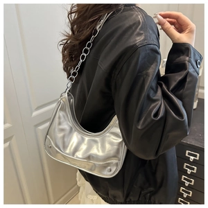 Detail of silver metallic hobo bag with pleated texture and silver chain strap