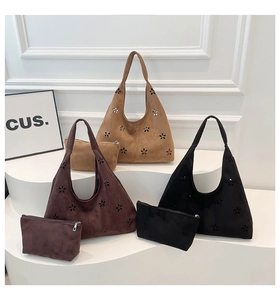 Detail of laser-cut floral patterns on matte faux suede hobo tote bag set with small pouch