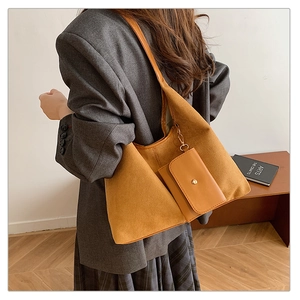 Close-up of caramel suede tote bag with matching pouch and gold snap button detail