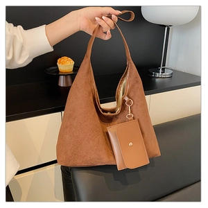 Detailed view of a brown suede hobo bag with a matching detachable small pouch