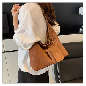 Brown suede tote bag detail featuring a matching detachable small pouch and gold ring