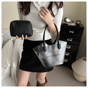 Detail of grey transparent PVC bucket bag with black leather inner pouch in a modern setting