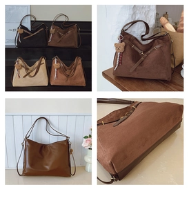 Detailed view of suede and leather tote bags with cross straps and bear charm accessory