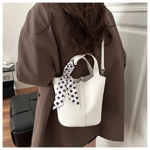 White litchi pattern bucket bag with polka dot scarf detail and crossbody strap