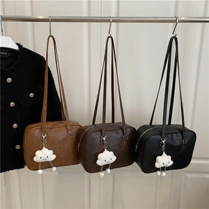 Three minimalist PU leather Boston shoulder bags in brown, coffee, and black with plush charms