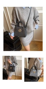 Dettaglio del motivo monogramma grigio e del logo M dorato sulla borsa in pelle