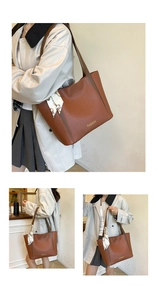 Détail d'un grand sac cabas en cuir marron avec texte doré et foulard en soie décoratif