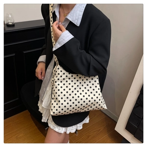 Close-up of stylish polka dot shoulder bag showing high-quality canvas fabric and texture