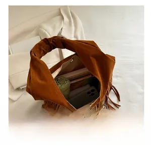 Internal storage detail of brown suede fringe bag with umbrella and daily essentials