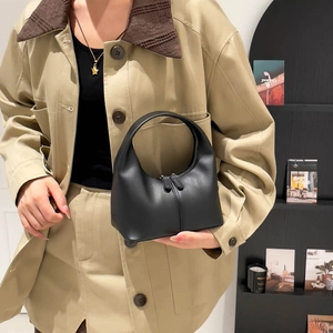 Chic black crescent leather handbag with dual zippers and minimalist stitched detail