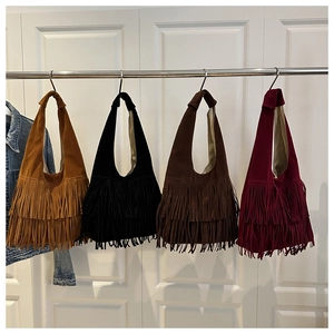 Detailed view of bohemian faux suede fringe tote bags in four rich seasonal colors