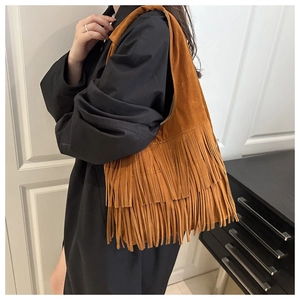 Dettaglio della borsa tote in pelle scamosciata marrone con frange stile bohémien