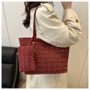 Model wearing red tweed tote bag with matching inner pouch and leather trim