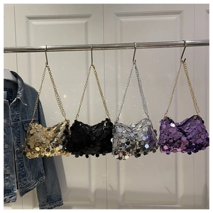 Detail view of large sequin handbags in gold, black, silver, and purple with metal chains