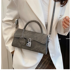 Gray marble texture handbag featuring metal lock and elegant top handle shown on model