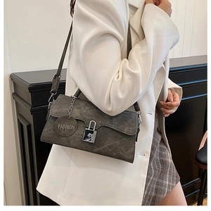 Detail of grey-green marble texture bag with silver buckle and fashion tag on model