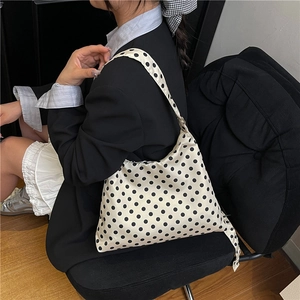 Chic cream hobo shoulder bag with black polka dots and wide strap for daily wear