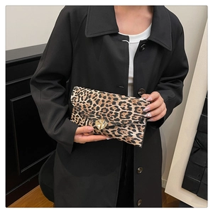 Detailed close-up of leopard print envelope clutch featuring a gold heart twist lock