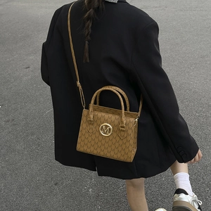Brown vintage faux leather tote bag with M-letter monogram and golden metal logo charm