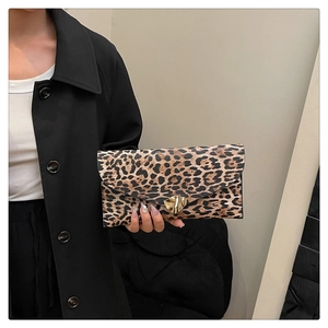 Detailed close-up of leopard print envelope clutch with a golden metal twist-lock fastener