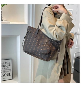 Close-up of large brown tote bag with bear pattern and matching round coin purse detail
