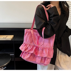 Detail of pink and white checkered tote bag with double-layered ruffles and drawstring