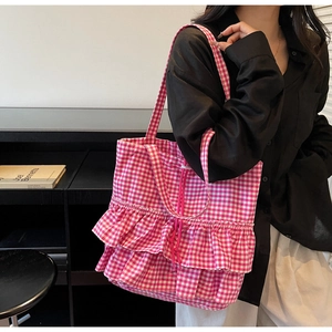 Detailed shot of pink and white checkered canvas tote bag with layered ruffle design