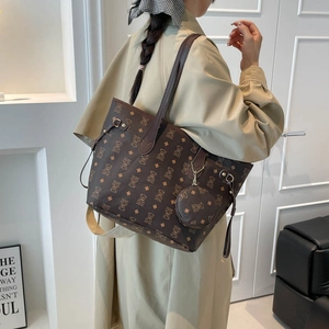 Brown leather tote bag with bear print pattern and matching coin purse charm