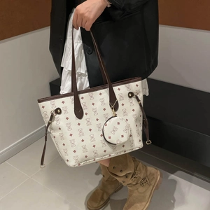 Minimalist tote bag with bear print and brown leather handles shown with a round coin purse