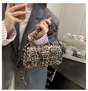 Detail shot of leopard print shoulder bag featuring punk silver rivets and metal eyelets