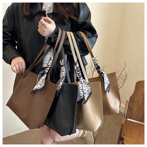 Detail view of four large capacity pleated tote bags with decorative artistic silk scarves
