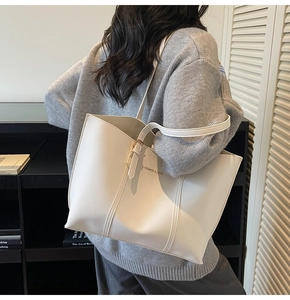 Détail d'un grand cabas blanc avec texte porté par un mannequin de profil