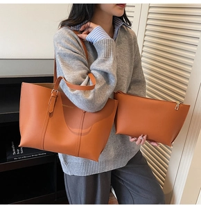 Detail of minimalist caramel tote bag set with matching zipper pouch and metal hardware