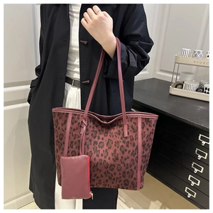 Detail of burgundy leopard print tote bag with attached small zipper coin purse