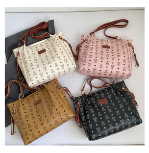 Flat lay of tote bags in four colors with bear pattern and vintage monogram design
