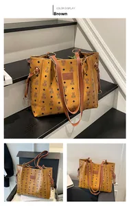 Detail view of brown large tote bag featuring bear print and gold metal buckles
