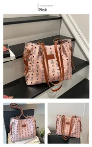 Detail of pink lychee texture tote bag with bear patterns and brown leather logo tag