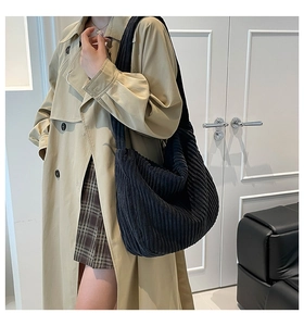 Detailed texture of black corduroy tote bag showing large capacity and soft fabric