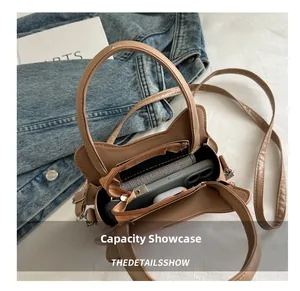 Internal view of the bread cat crossbody bag showing zipper compartment and storage capacity