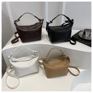 Detail showing woven leather texture in four colors on a minimalist display stand